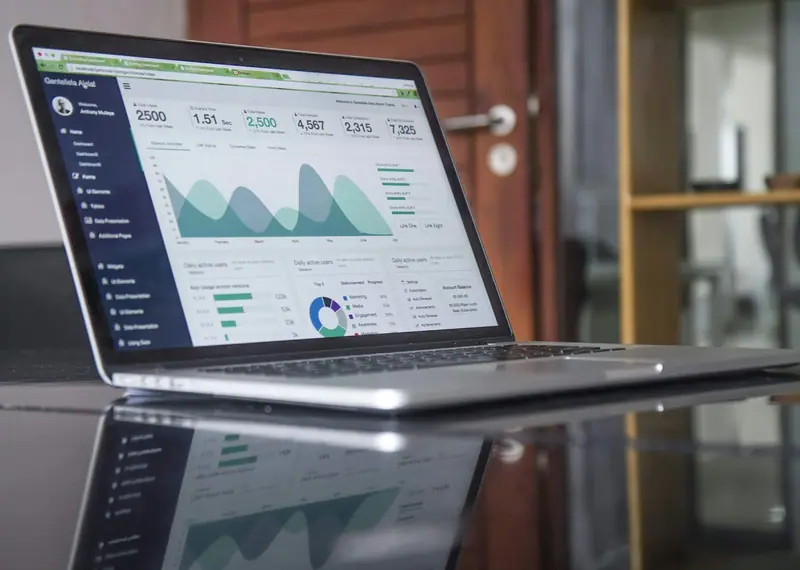 Small business owner reviewing website analytics on a laptop